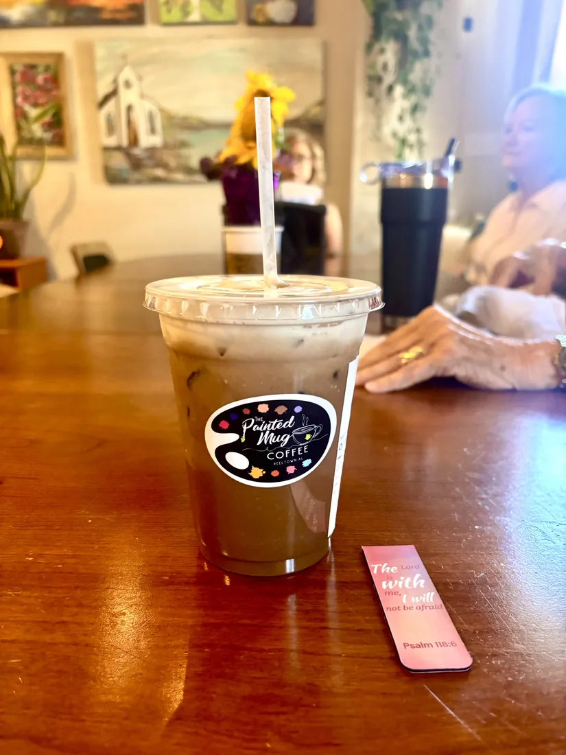 An iced coffee from The Painted Mug beside a Psalm 118:6 bookmark
